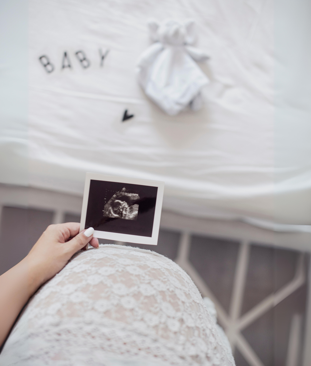 pregnant woman holding a baby ultrasound image