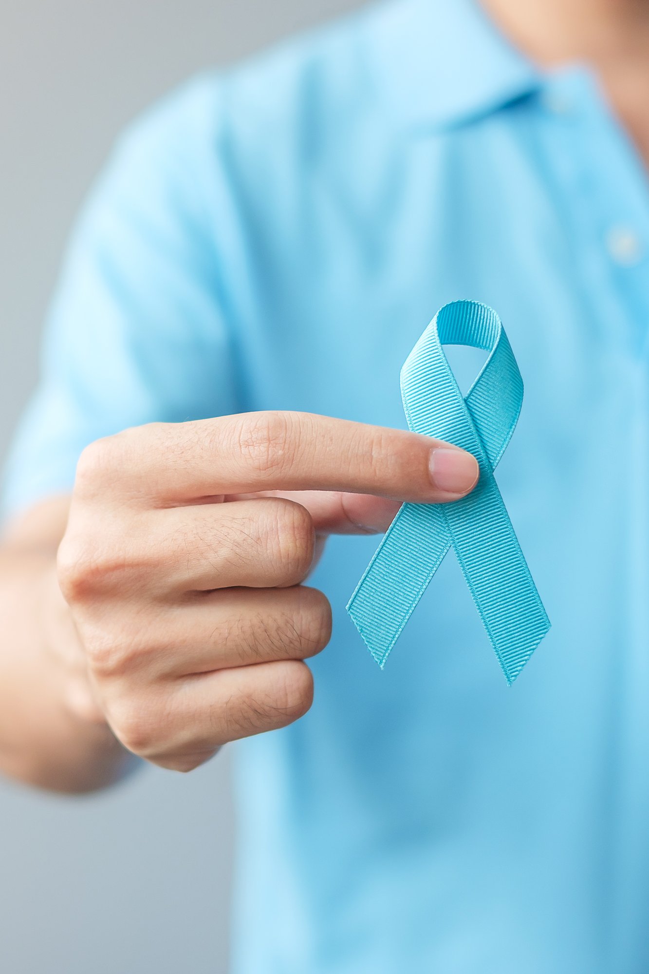 november-prostate-cancer-awareness-month-man-blue-shirt-with-hand-holding-blue-ribbon-international-men-father-world-cancer-day-concept